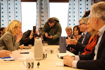 Furniture ,Table ,Outerwear ,Social group ,Coat.