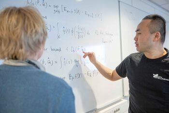 Illustration of researchers infront of the board with mathematical formulas portraying a work situation.